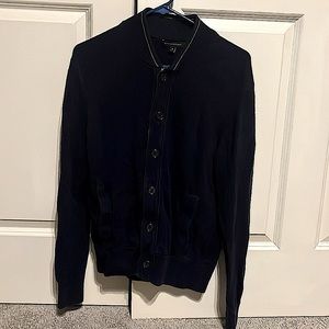 Navy blue. 100% cotton cardigan sweater. Gray detail along buttons and collar